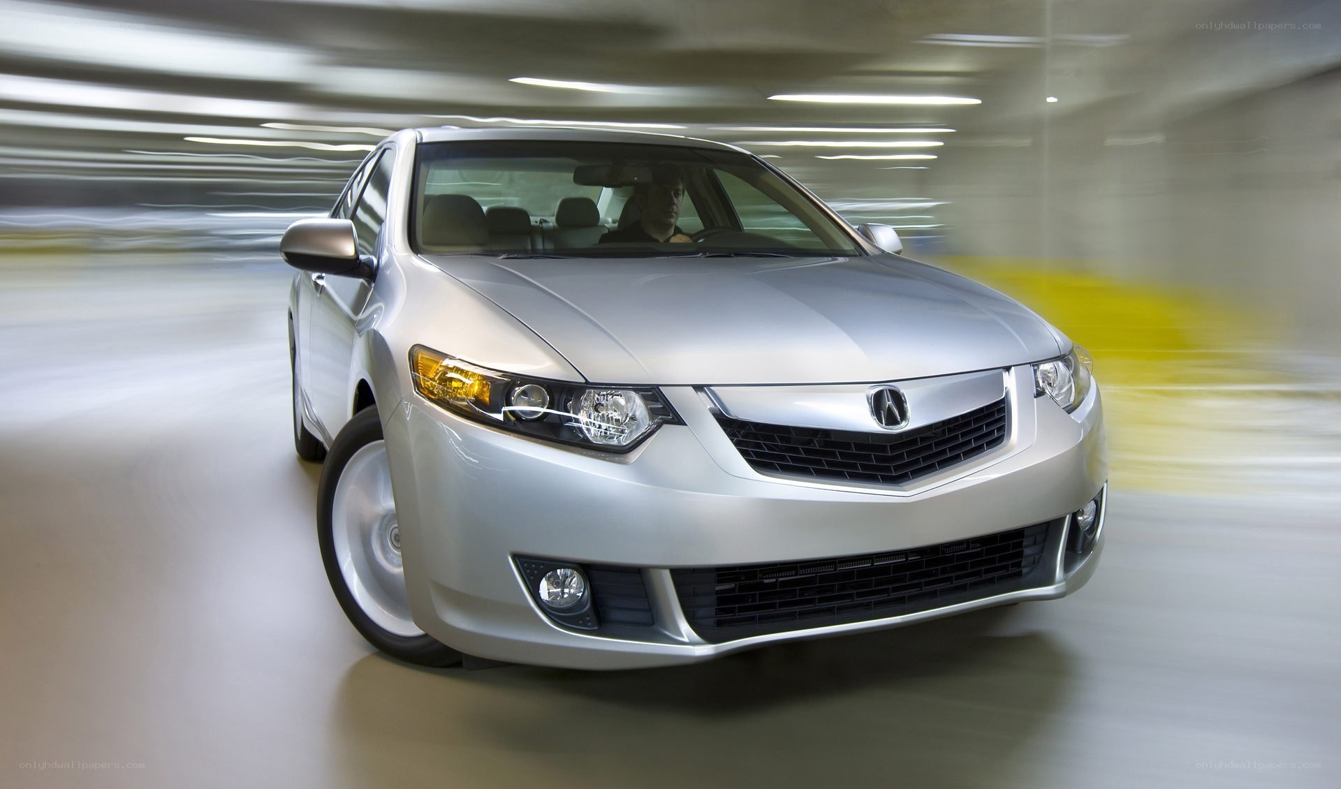 silver acura sedan in motion