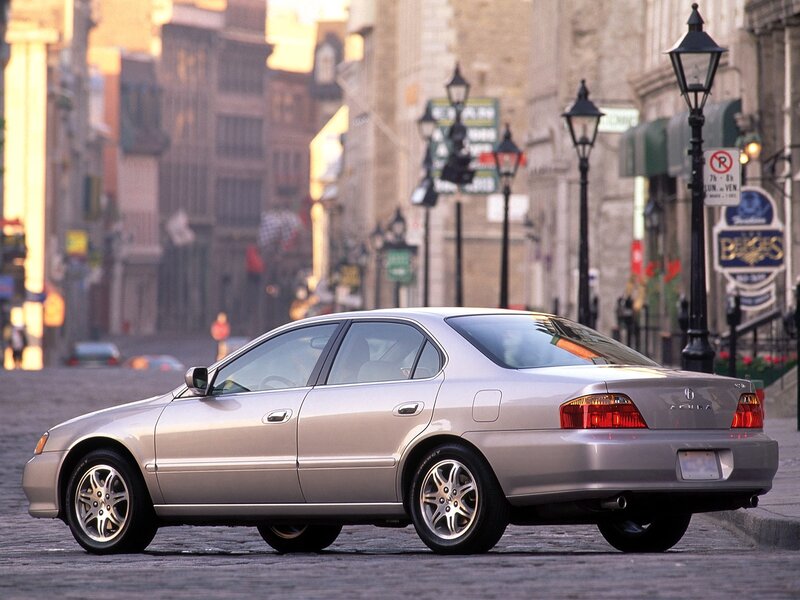 silver acura sedans on cobblestone street