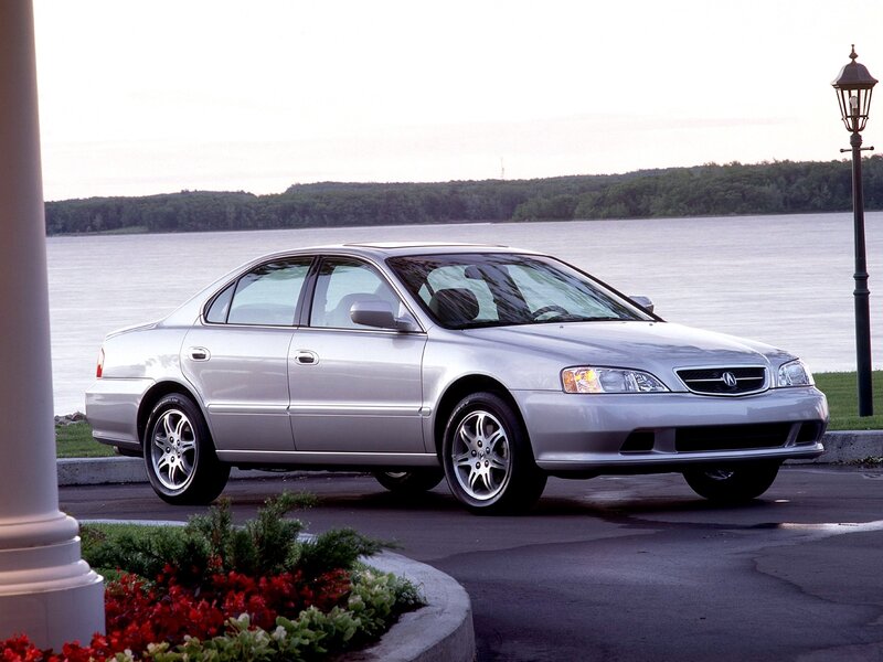 Silver Acura TL by the water