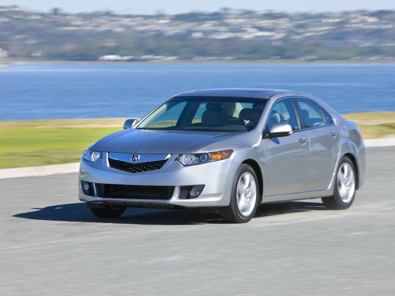 Silver Acura TL driving on coastal road