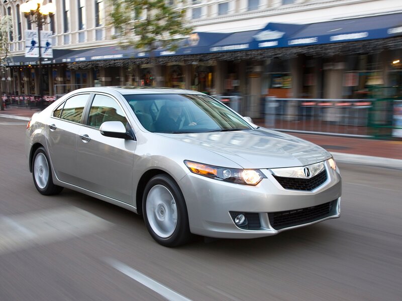 Silver Acura TL in city traffic