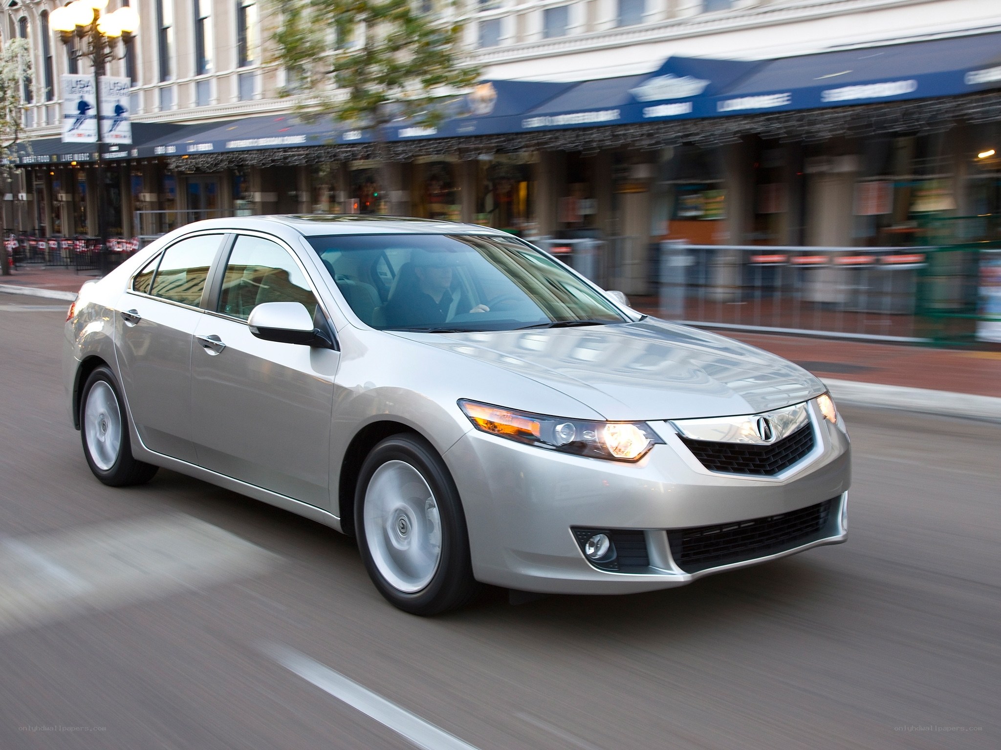 Silver Acura TL in city traffic