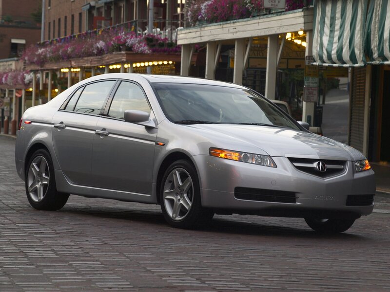 silver acura tl on cobblestone street