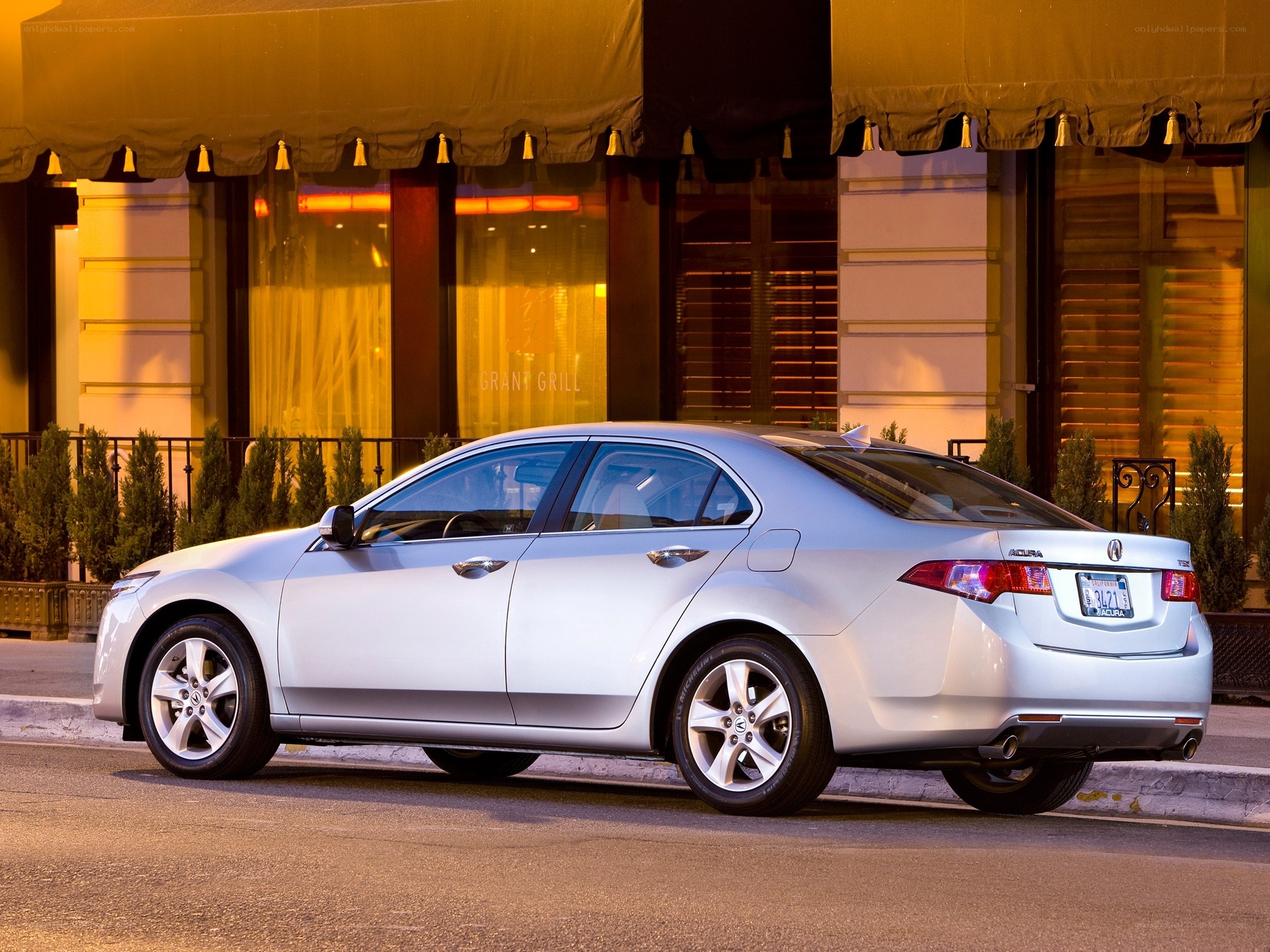 Silver Acura TL parked at night