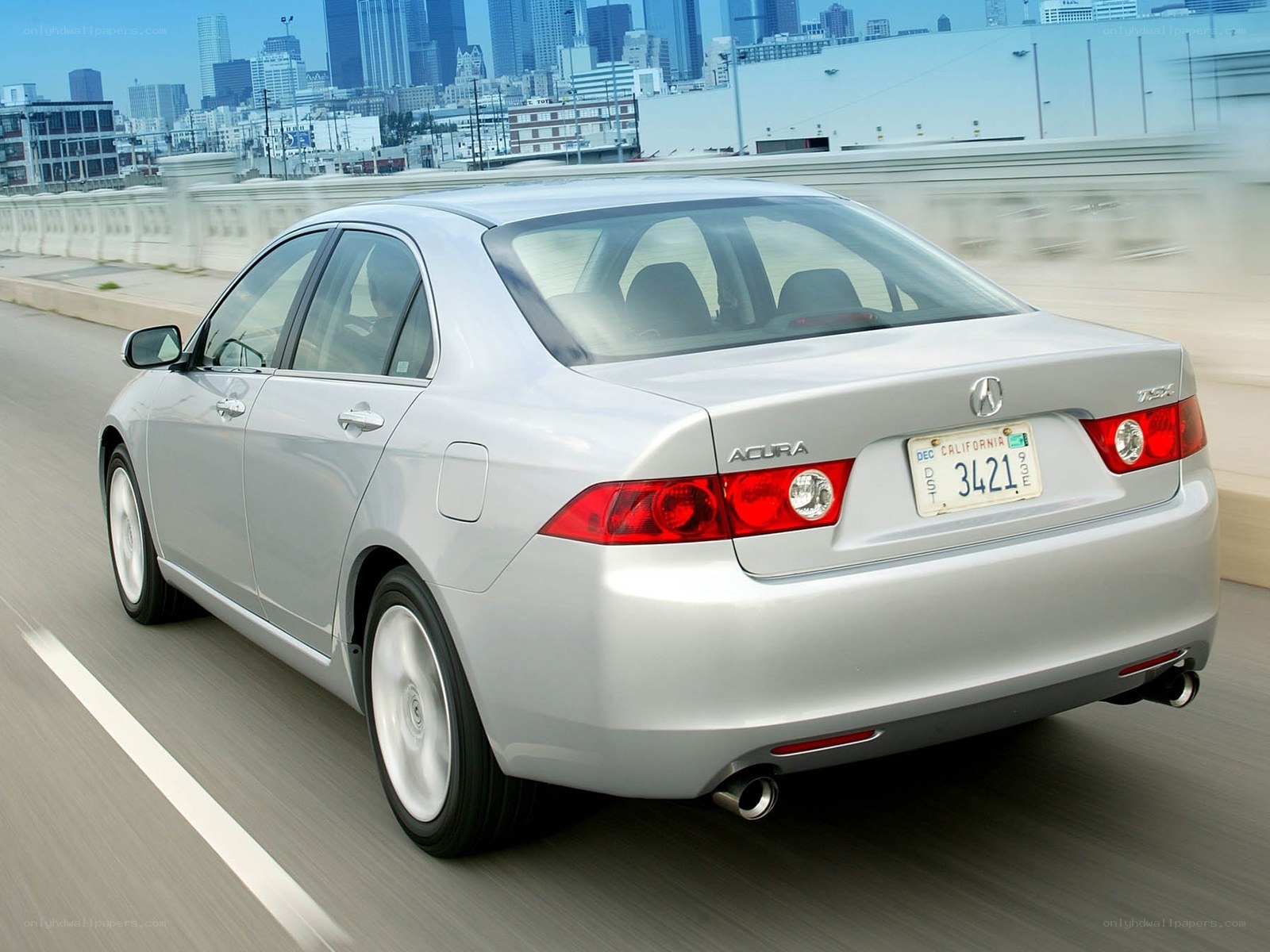 silver acura tsx driving on bridge