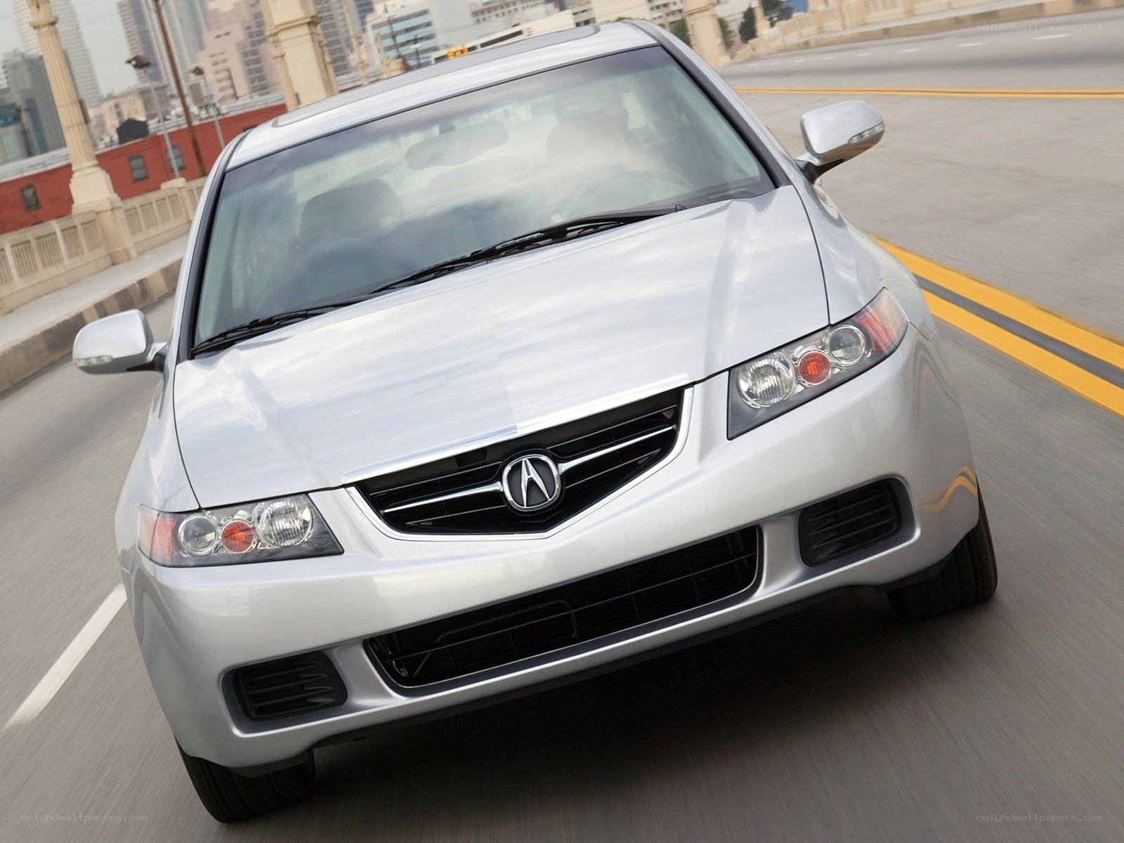 silver acura tsx driving on bridge