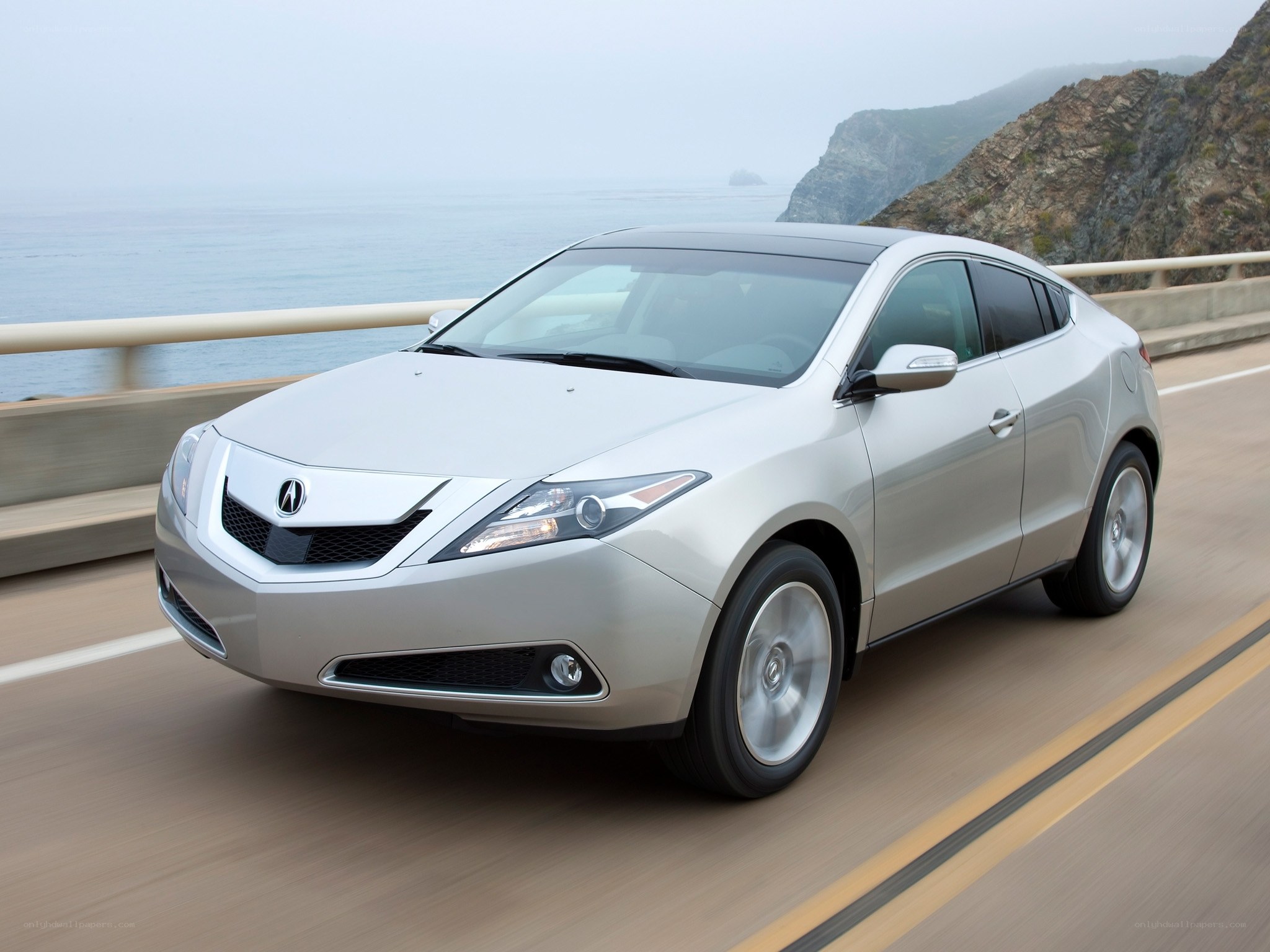 silver acura zdx driving on coastal road
