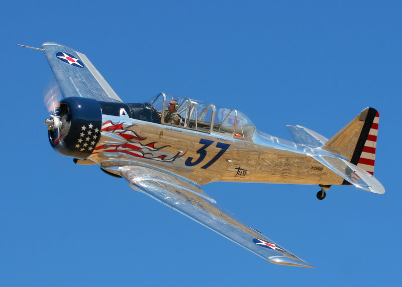 Silver Airplane in Flight — Blue