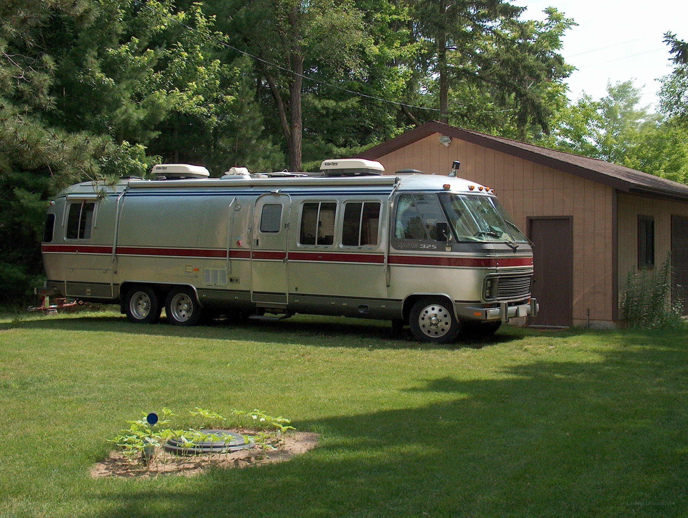 Silver Airstream RV in backyard