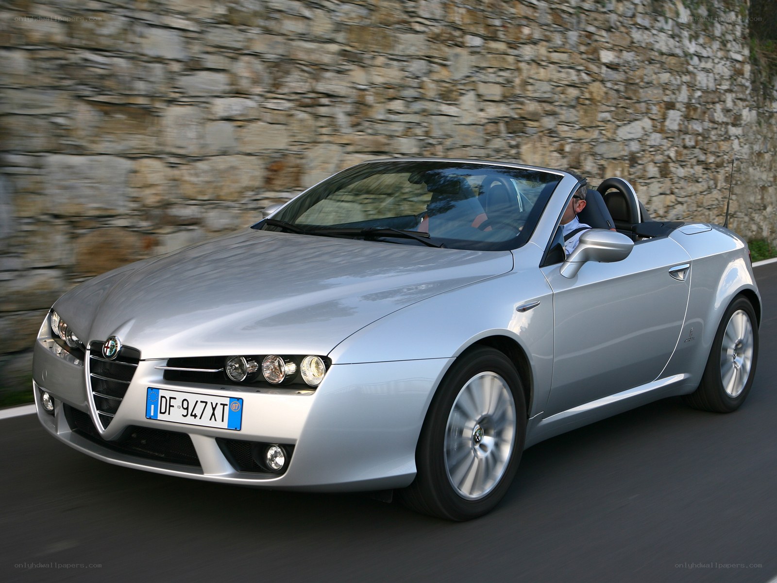 silver alfa romeo convertible driving