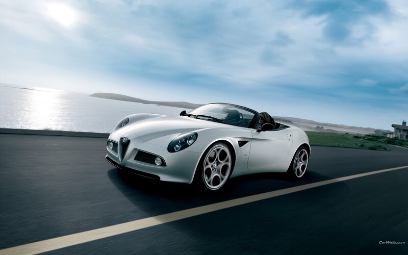 Silver Alfa Romeo convertible on coastal road