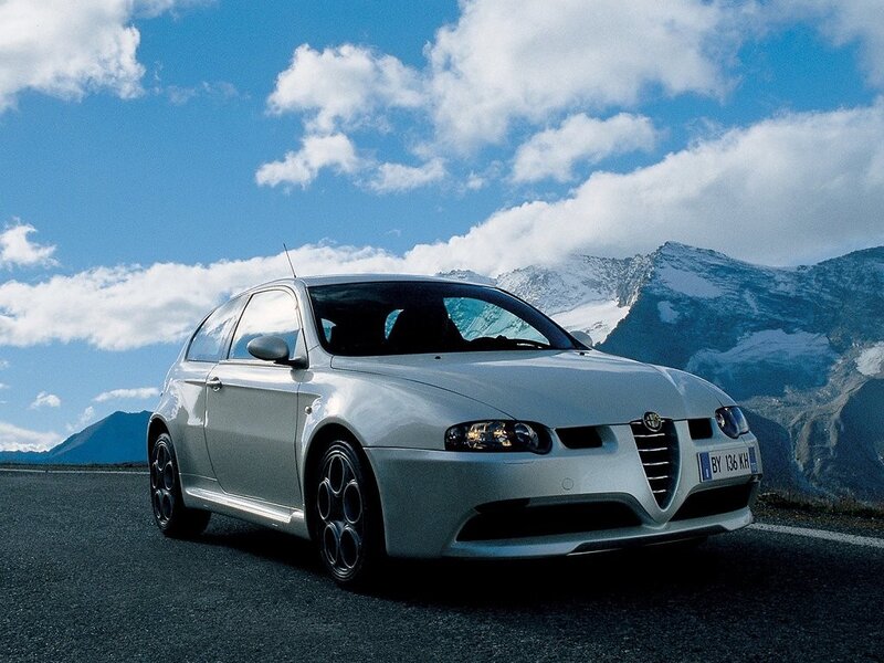 silver alfa Romeo on mountain road
