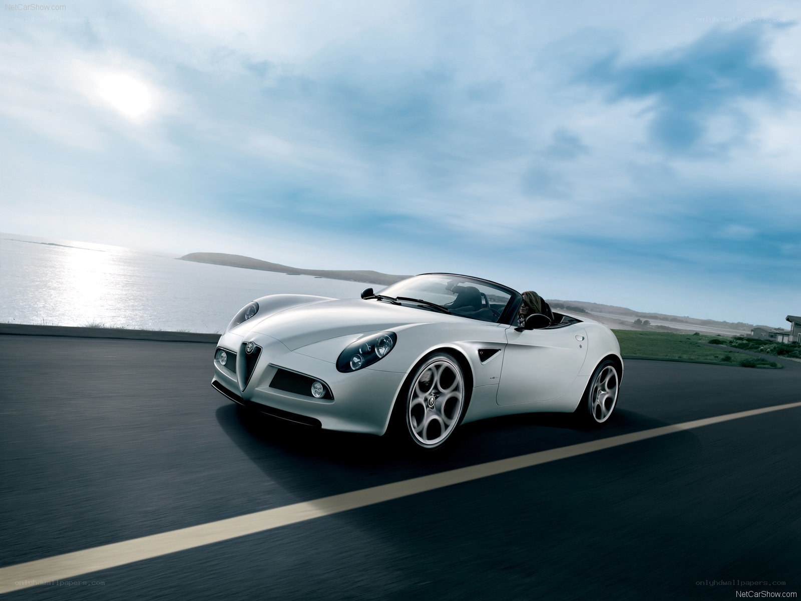 silver alfa romeo spider driving