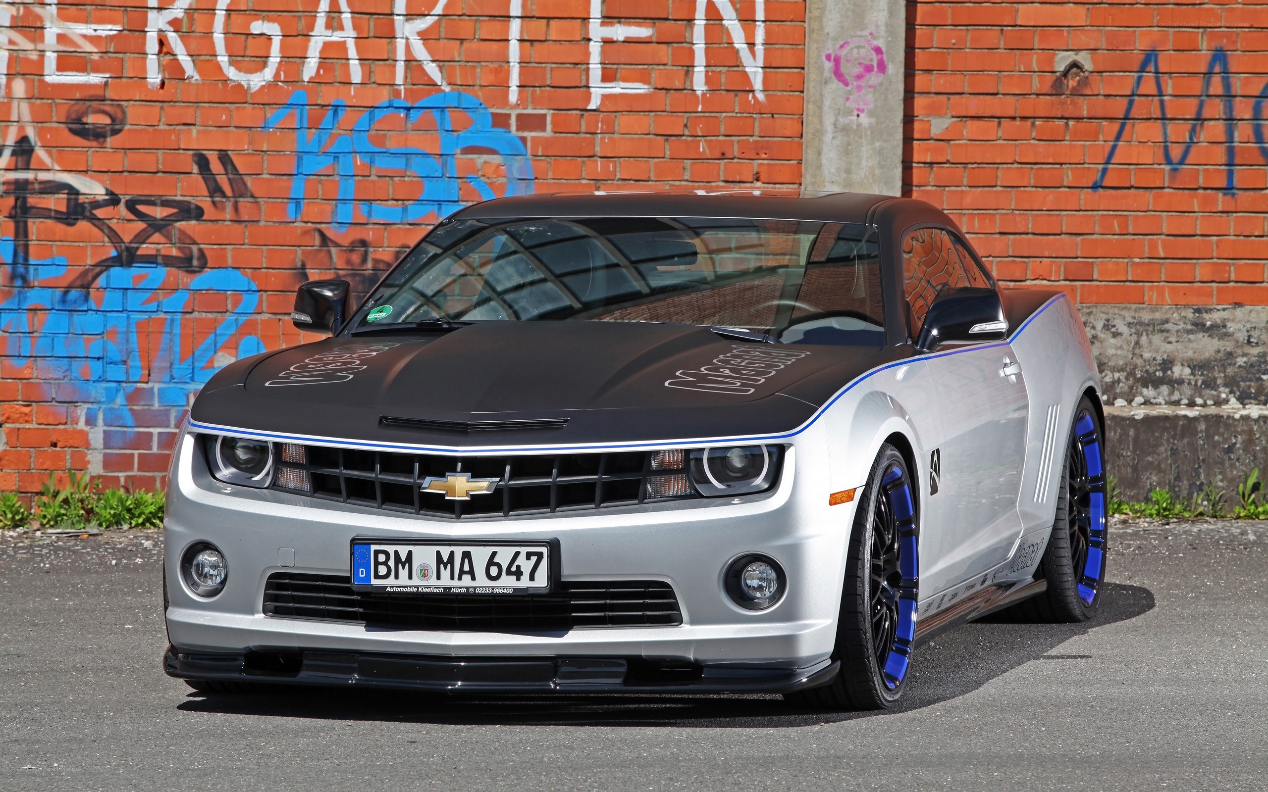 Silver and black Camaro with custom wheels