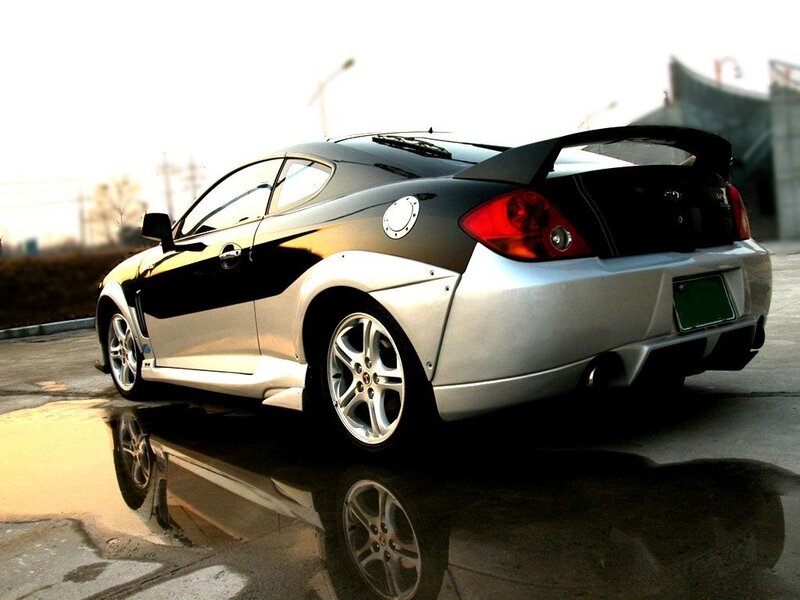 silver and black coupe with rear spoiler