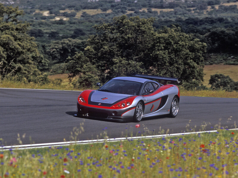 Silver and red sports car on track