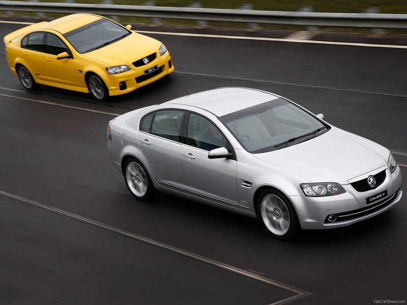 Silver and yellow Holden sedans