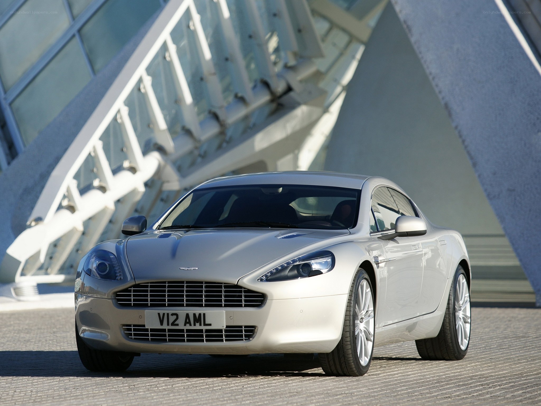 silver aston martin at modern building