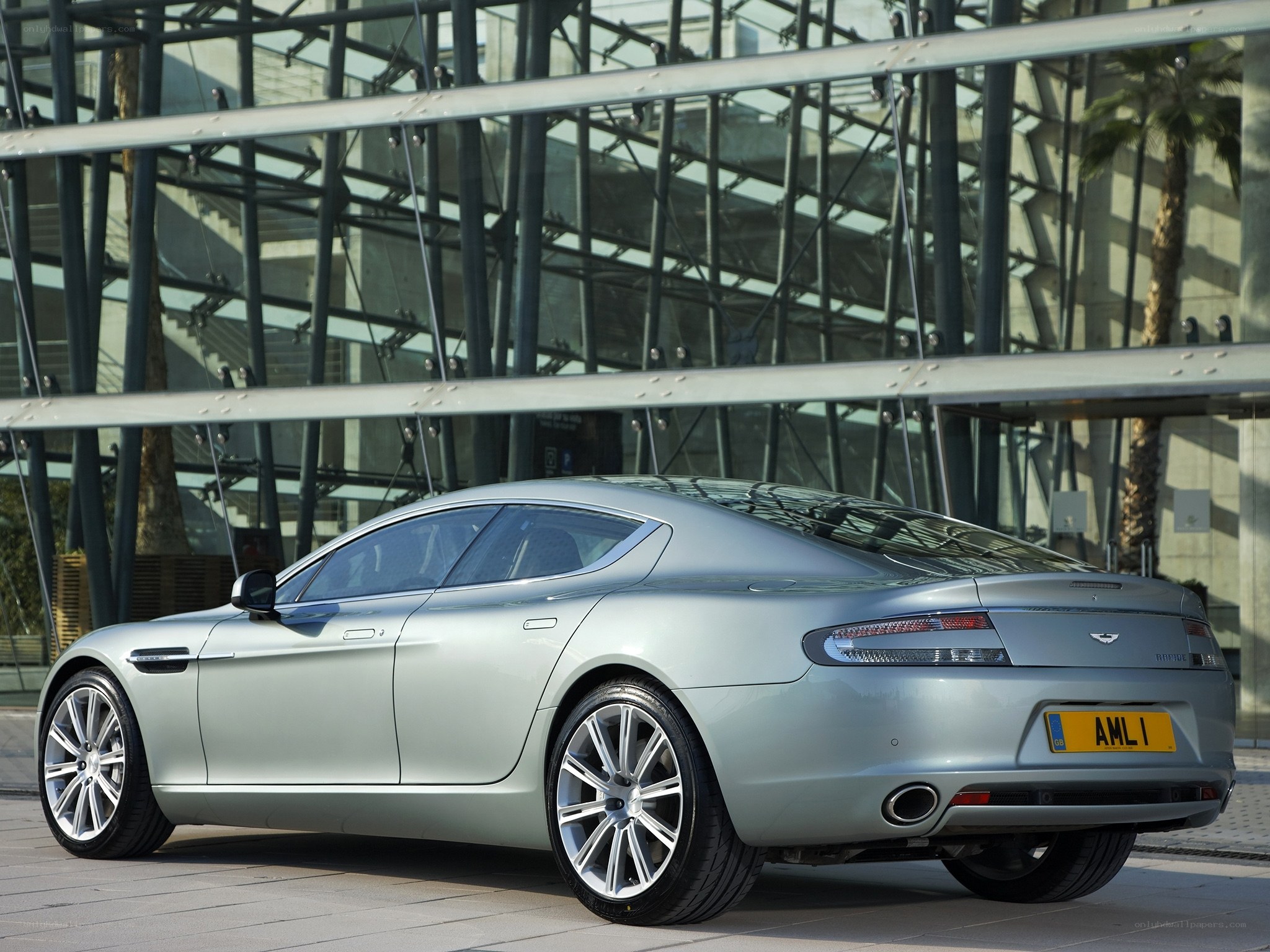 silver aston martin at modern building
