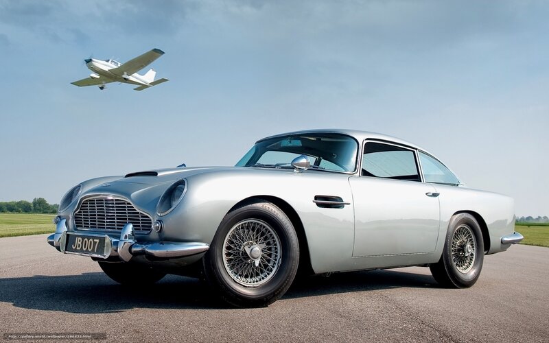 Silver Aston Martin DB5 with plane