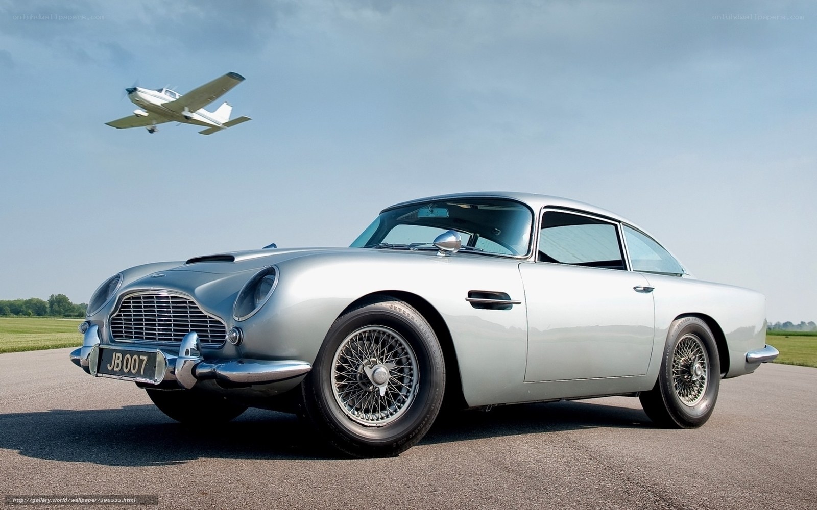 Silver Aston Martin DB5 with plane