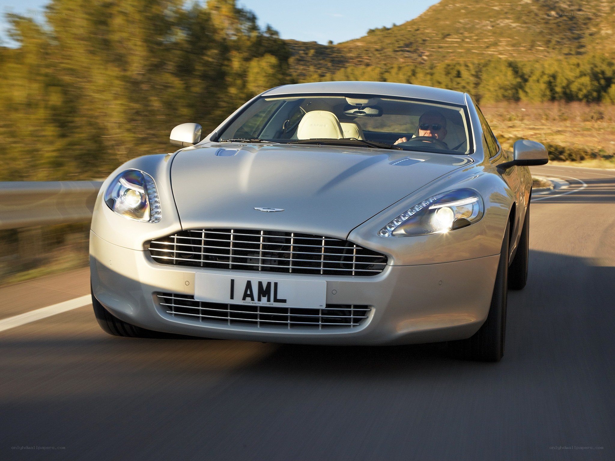 silver aston martin driving