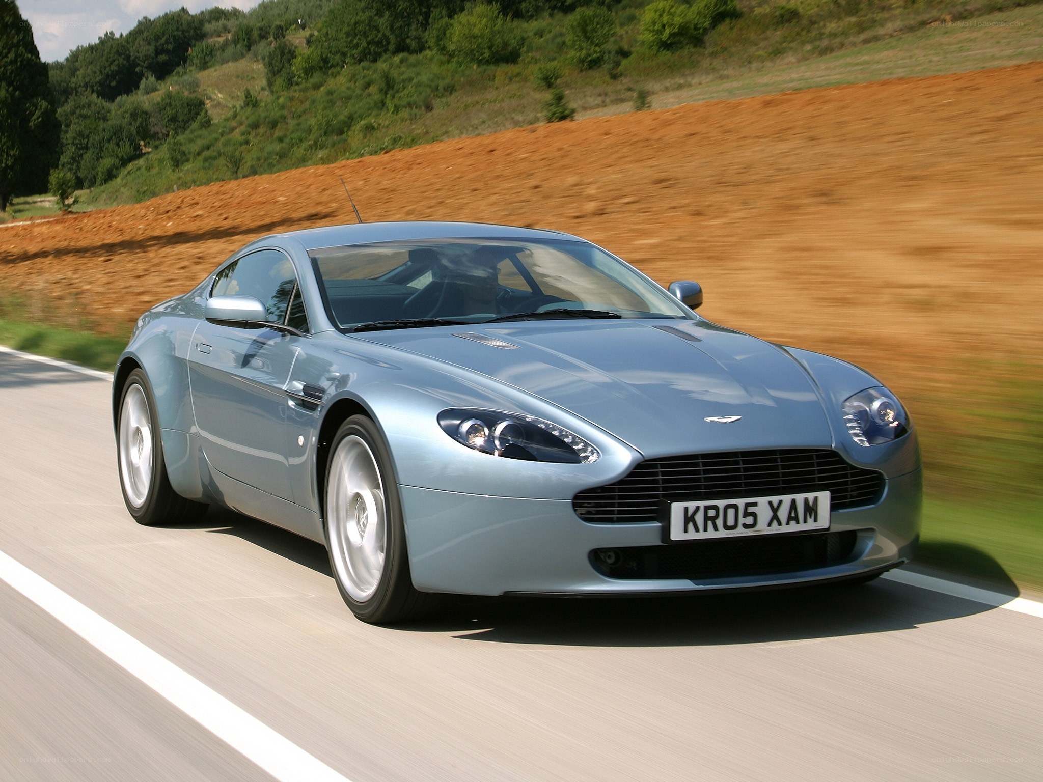silver aston martin driving