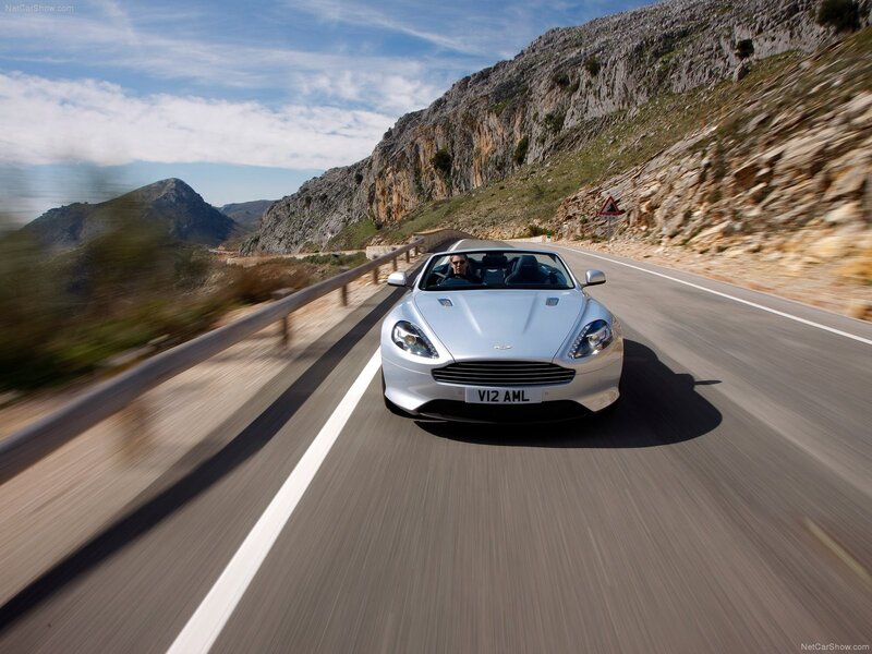 silver aston martin driving