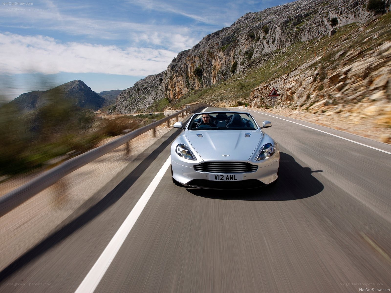 silver aston martin driving