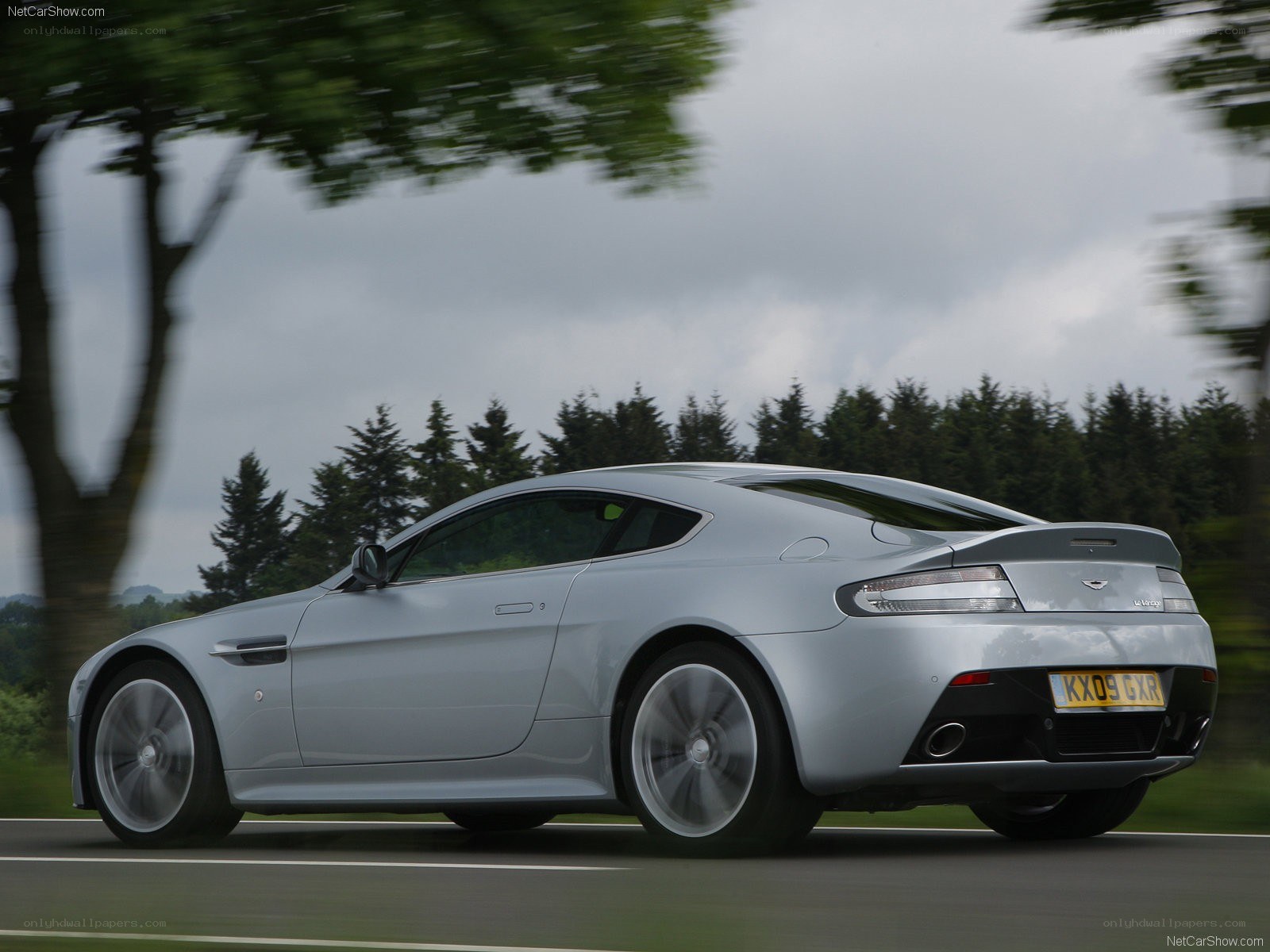 silver aston martin driving