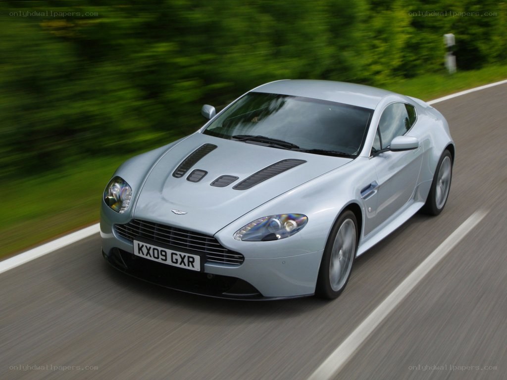 silver aston martin driving
