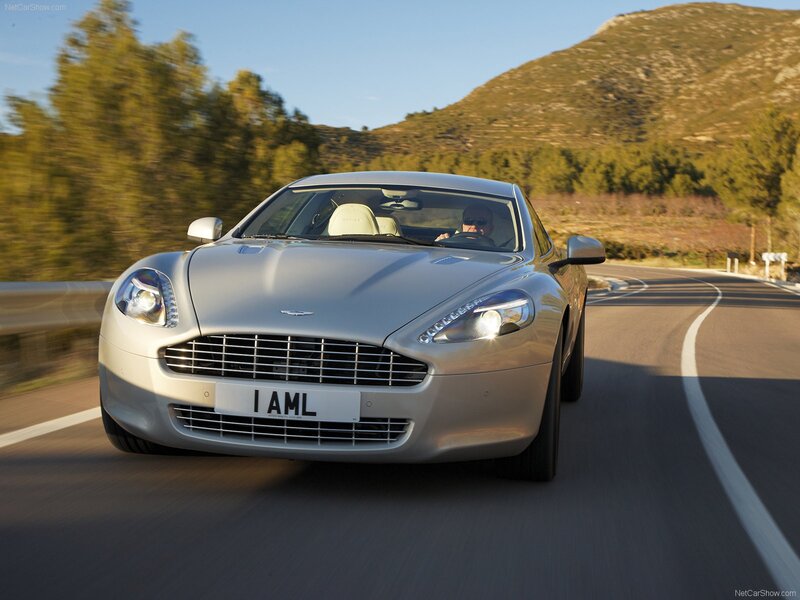 silver aston martin driving on road