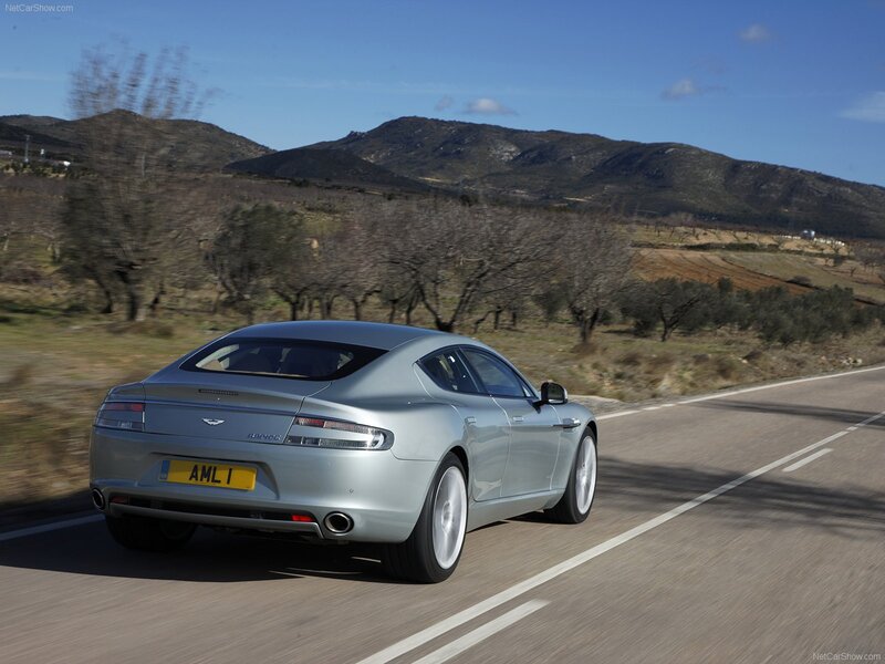 silver aston martin driving on road
