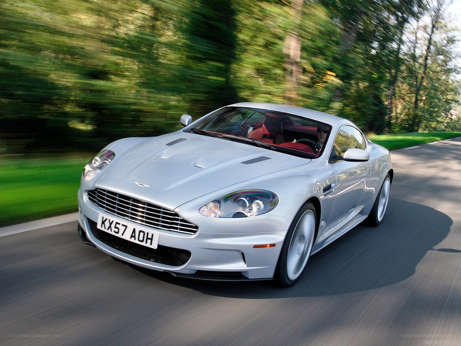 silver aston martin driving on road