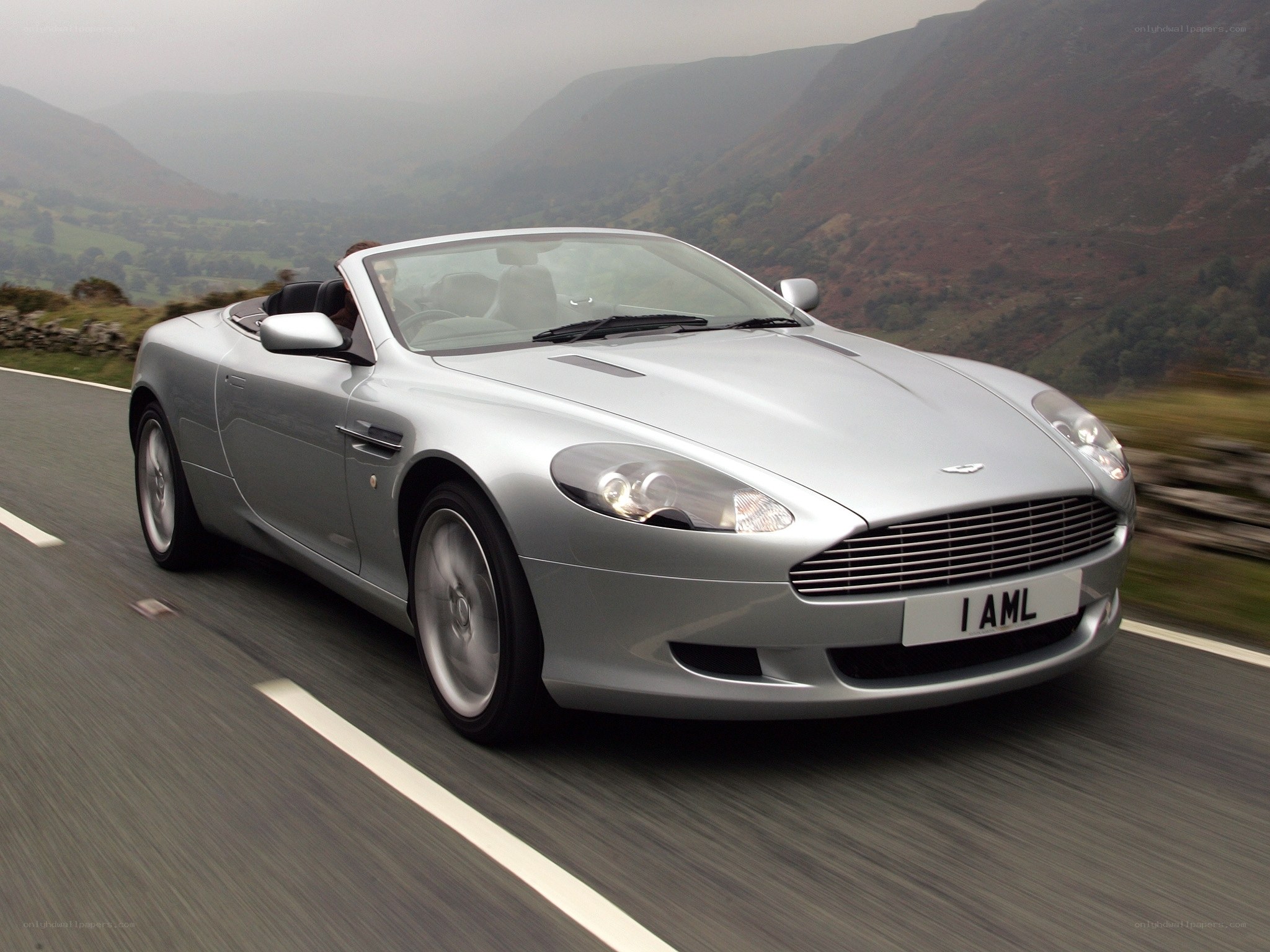 silver aston martin driving