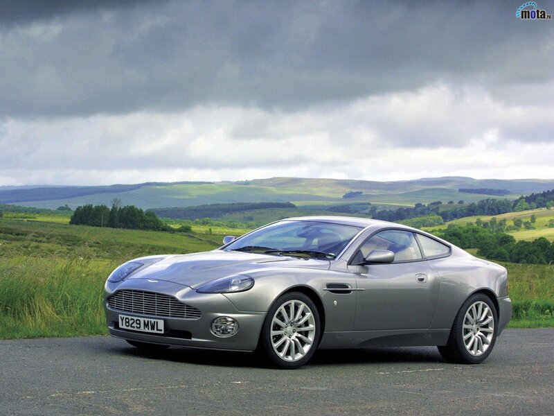 Silver Aston Martin in a scenic landscape