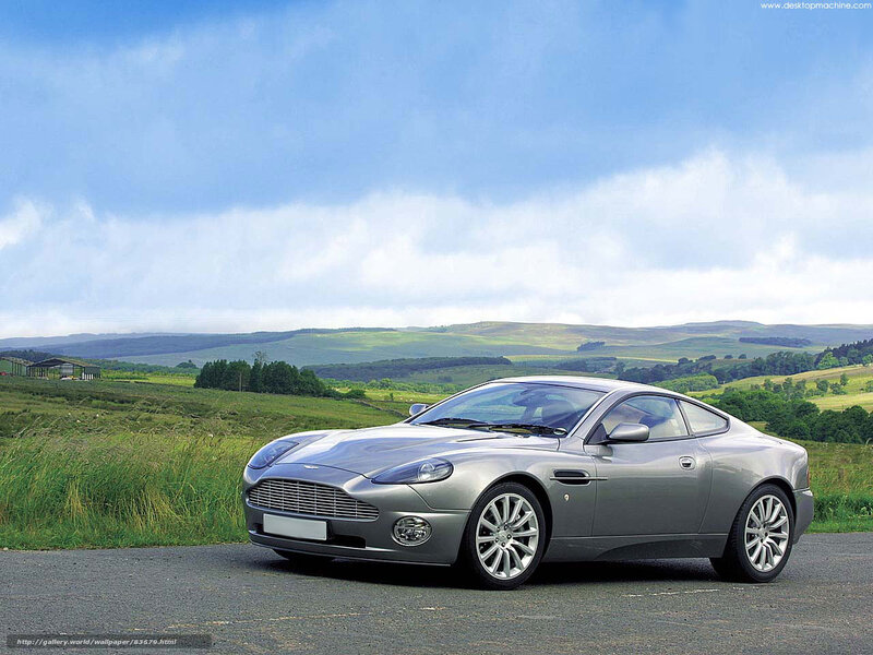Silver Aston Martin in a scenic landscape