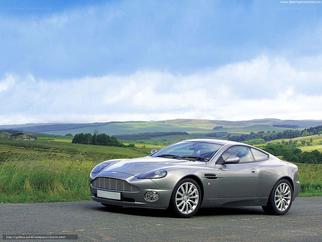 Silver Aston Martin in a scenic landscape