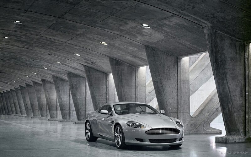 Silver Aston Martin in concrete tunnel