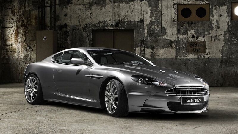 Silver Aston Martin in industrial setting