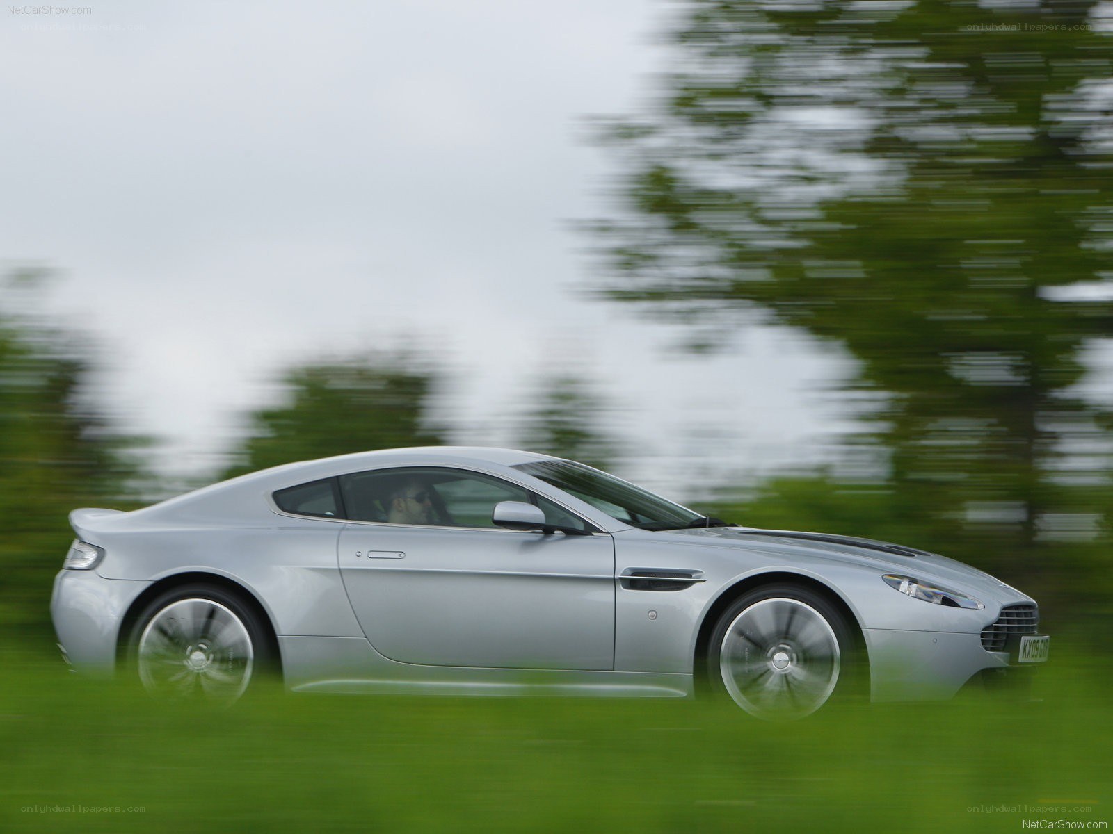 silver aston martin in motion