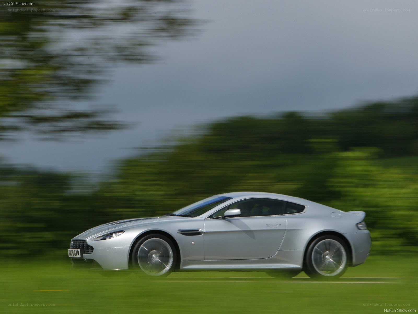 silver aston martin in motion