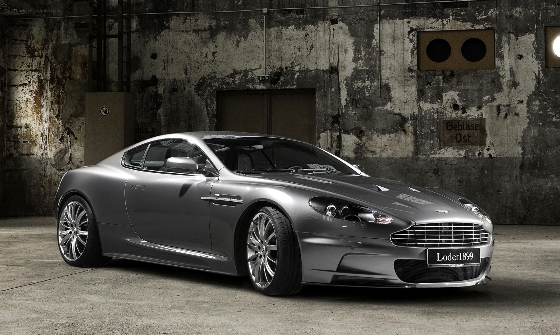 Silver Aston Martin in warehouse