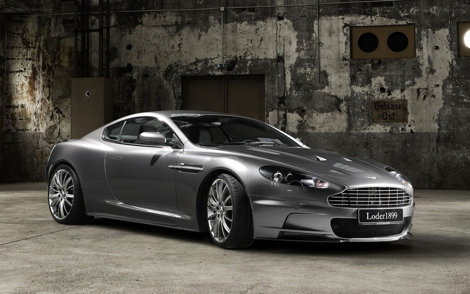 Silver Aston Martin in warehouse