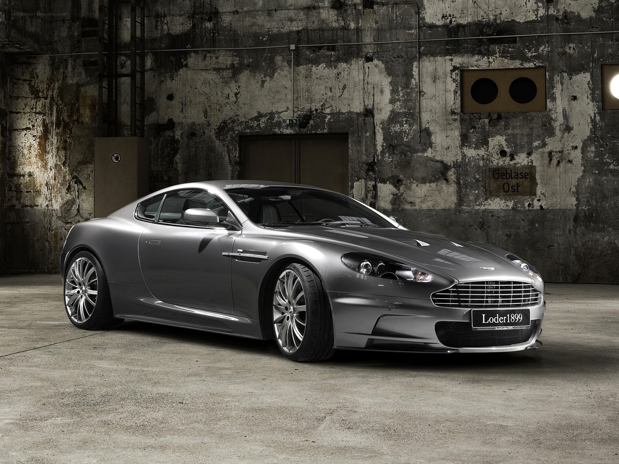Silver Aston Martin in warehouse