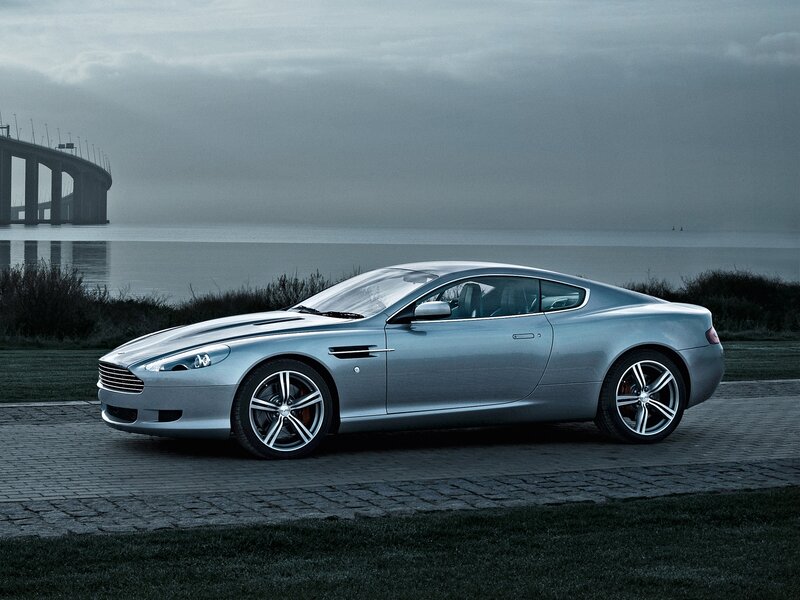 Silver Aston Martin on a coastal road
