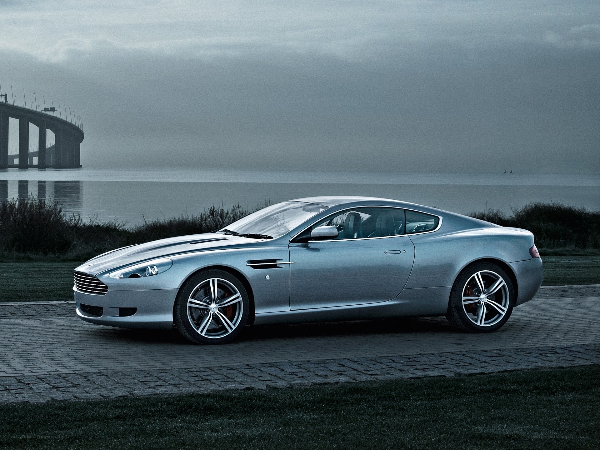 Silver Aston Martin on a coastal road