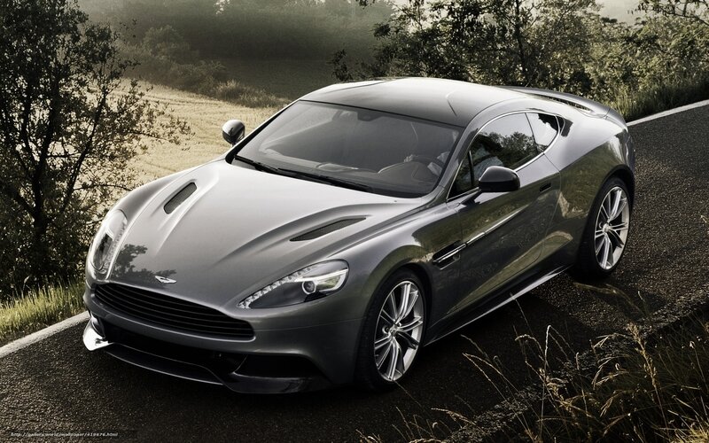 Silver Aston Martin on a country road