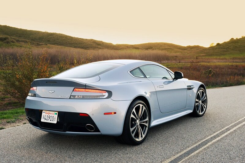 Silver Aston Martin on a country road
