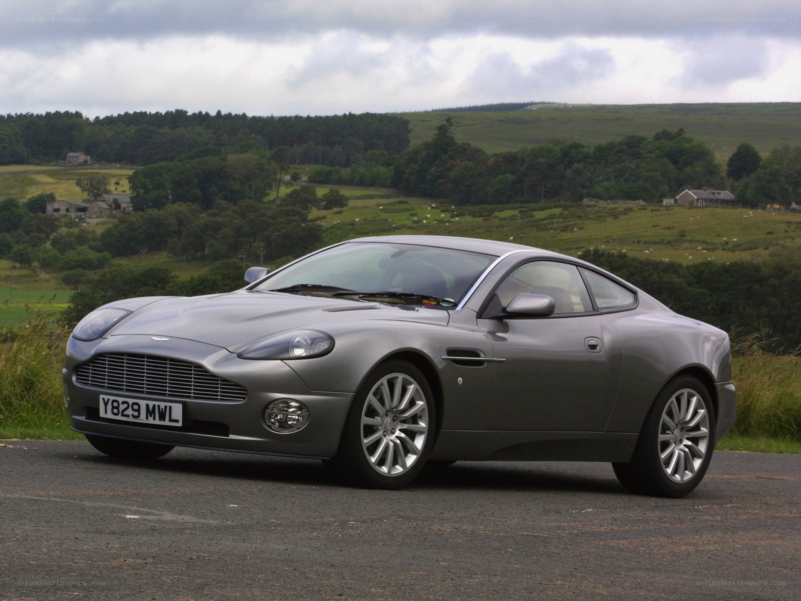 Silver Aston Martin on a country road